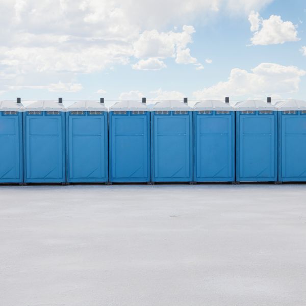 Jobsite porta potty rental beside construction equipment in Ohio and the Midwest